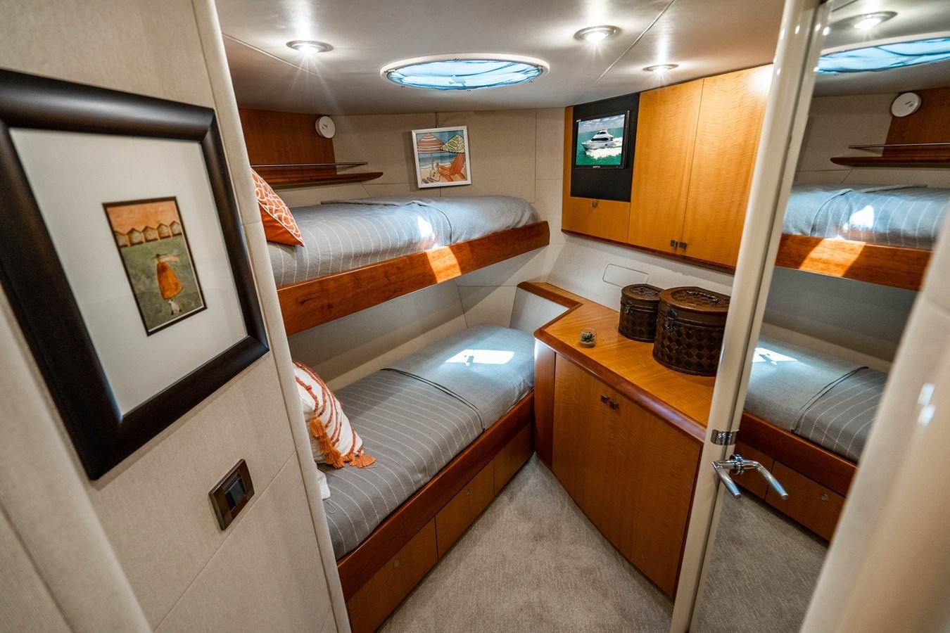 a room with a bed and a desk aboard VOYAGER Yacht for Sale