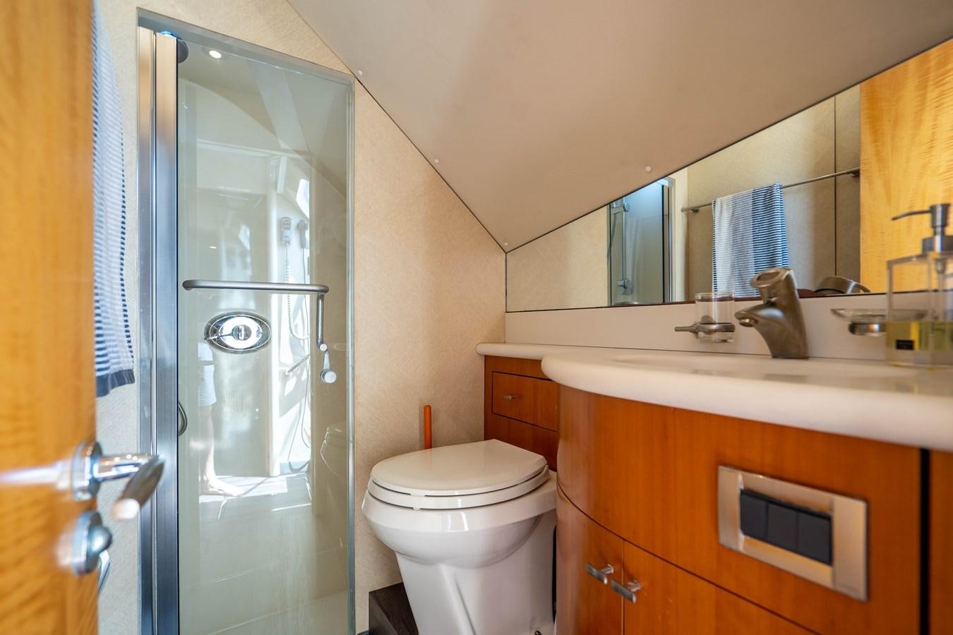 a bathroom with a glass shower door aboard VOYAGER Yacht for Sale