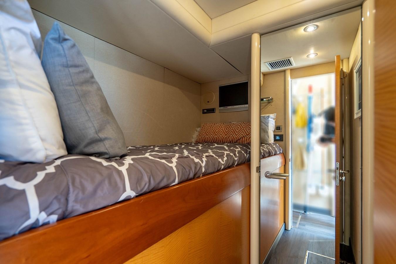 a bedroom with a bed and a door aboard VOYAGER Yacht for Sale