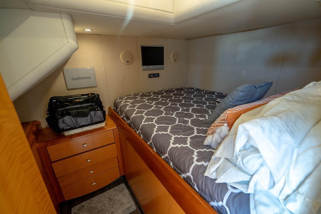 a bed with a blue comforter aboard VOYAGER Yacht for Sale