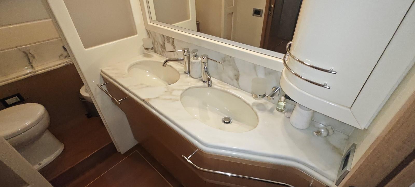 a bathroom with a sink and a toilet aboard MAYBE NOT Yacht for Sale