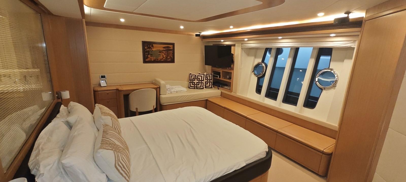 a room with a bed and a desk aboard MAYBE NOT Yacht for Sale