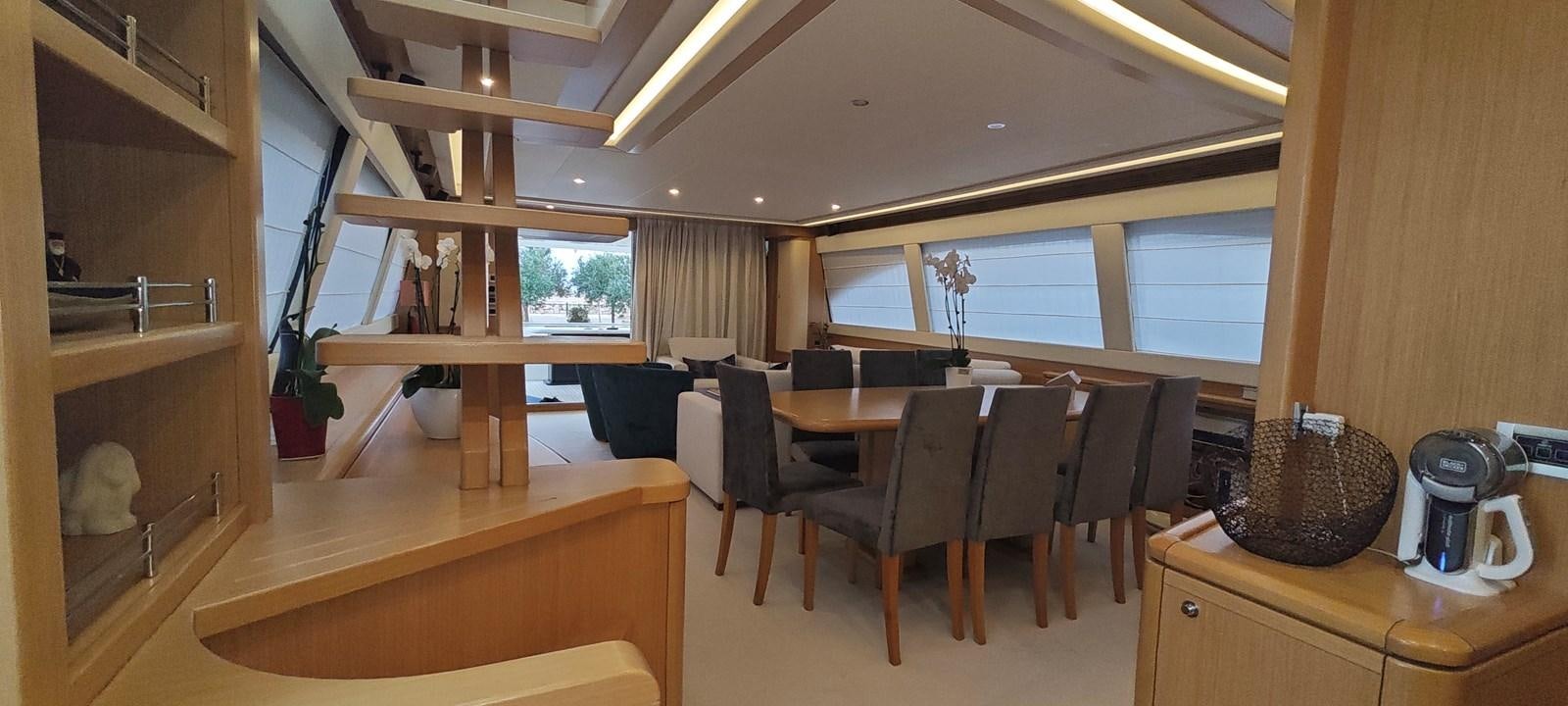 a kitchen with a table and chairs aboard MAYBE NOT Yacht for Sale