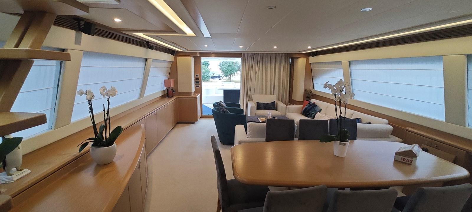 a room with a table chairs and a window aboard MAYBE NOT Yacht for Sale