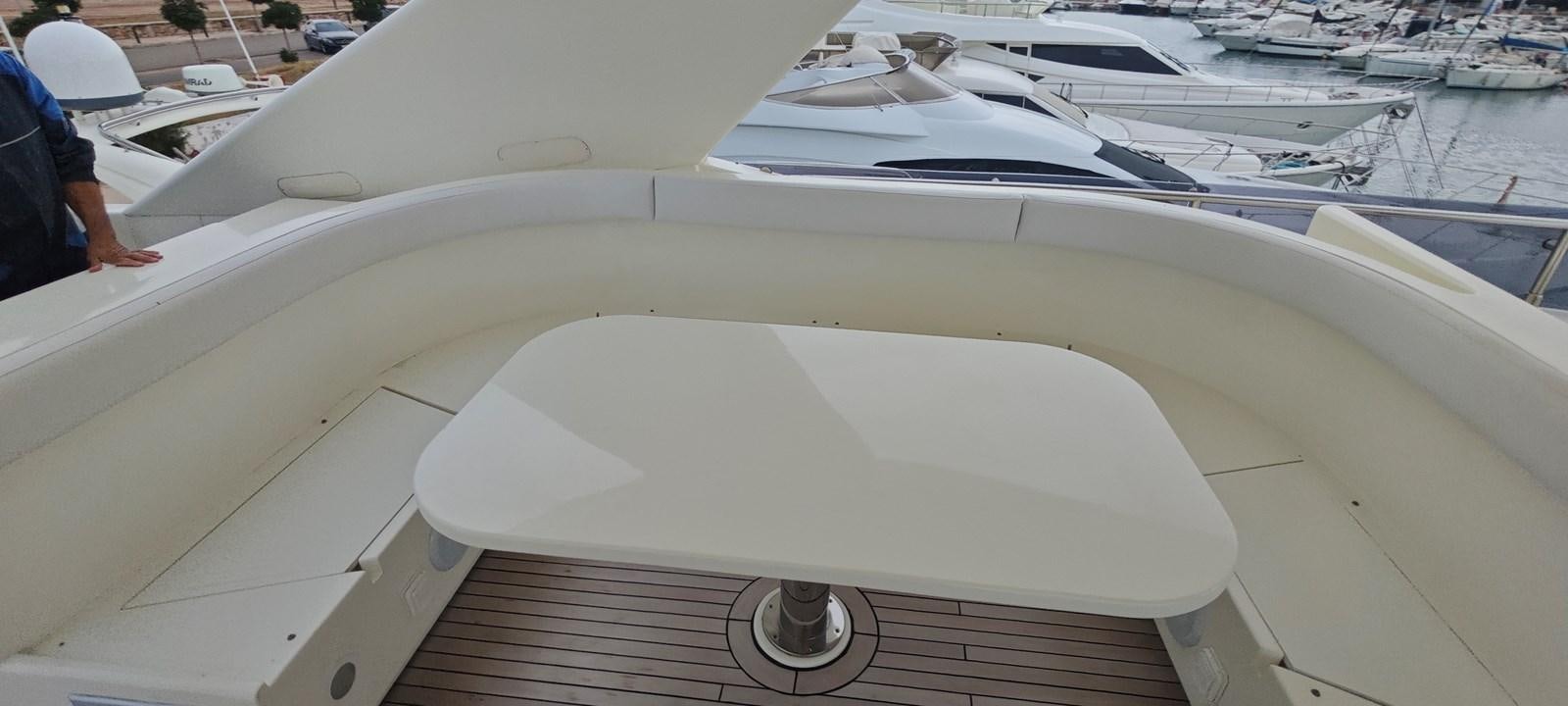 a white boat with a white cover aboard MAYBE NOT Yacht for Sale