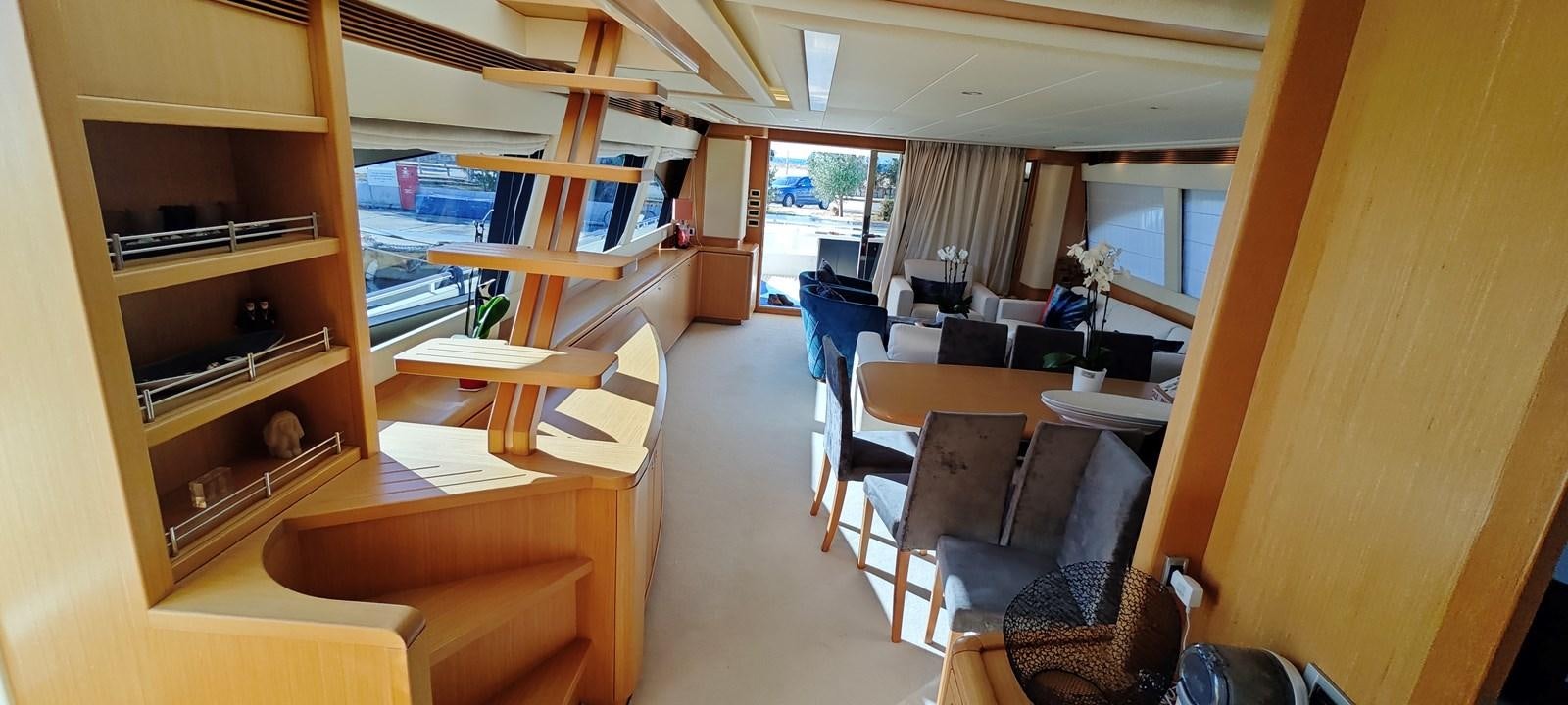 a room with a wood staircase and a desk with chairs and a window aboard MAYBE NOT Yacht for Sale