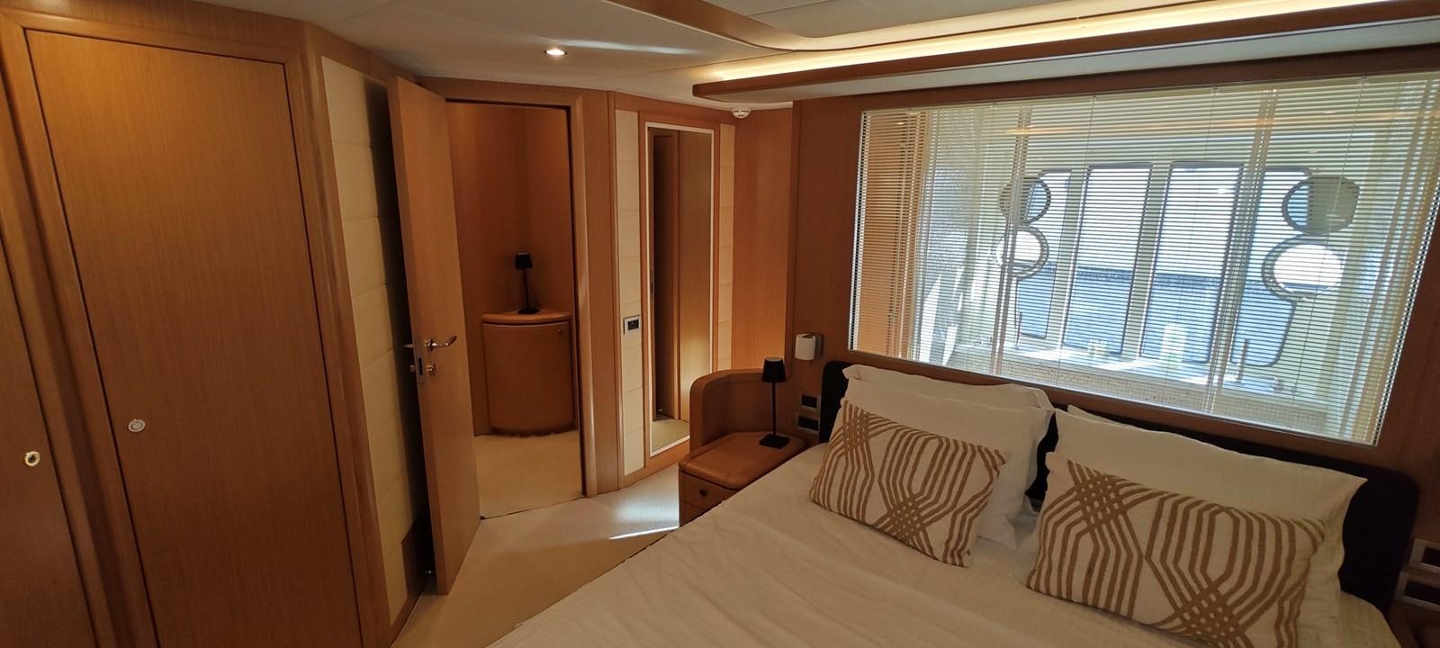a room with a bed and a chair aboard MAYBE NOT Yacht for Sale