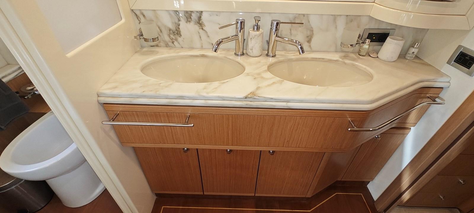 a bathroom with a sink and a toilet aboard MAYBE NOT Yacht for Sale