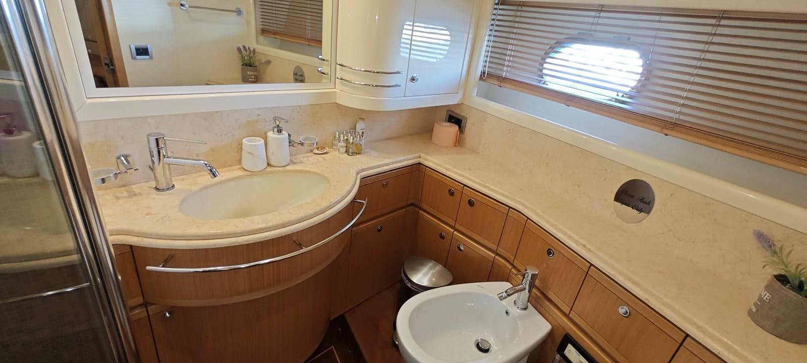 a bathroom with a sink and a mirror aboard MAYBE NOT Yacht for Sale