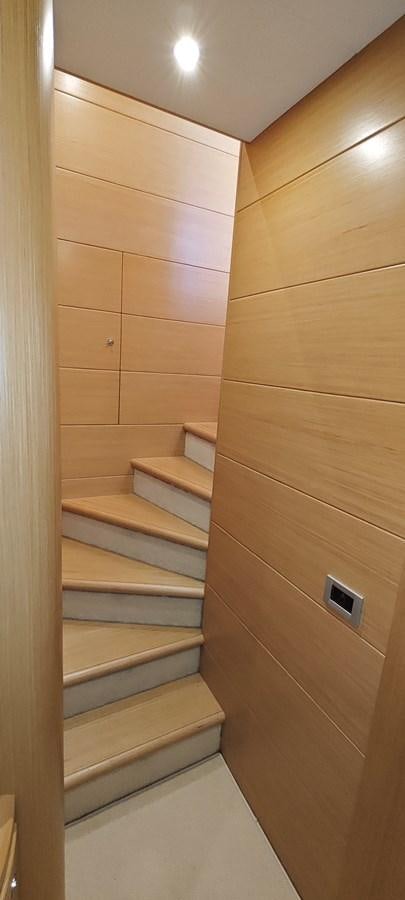 a wooden staircase with wooden drawers aboard MAYBE NOT Yacht for Sale