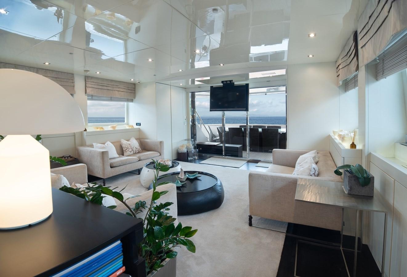 a living room with a large screen aboard XANAX Yacht for Sale