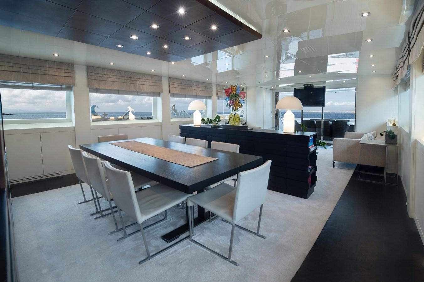 a room with a table and chairs aboard XANAX Yacht for Sale