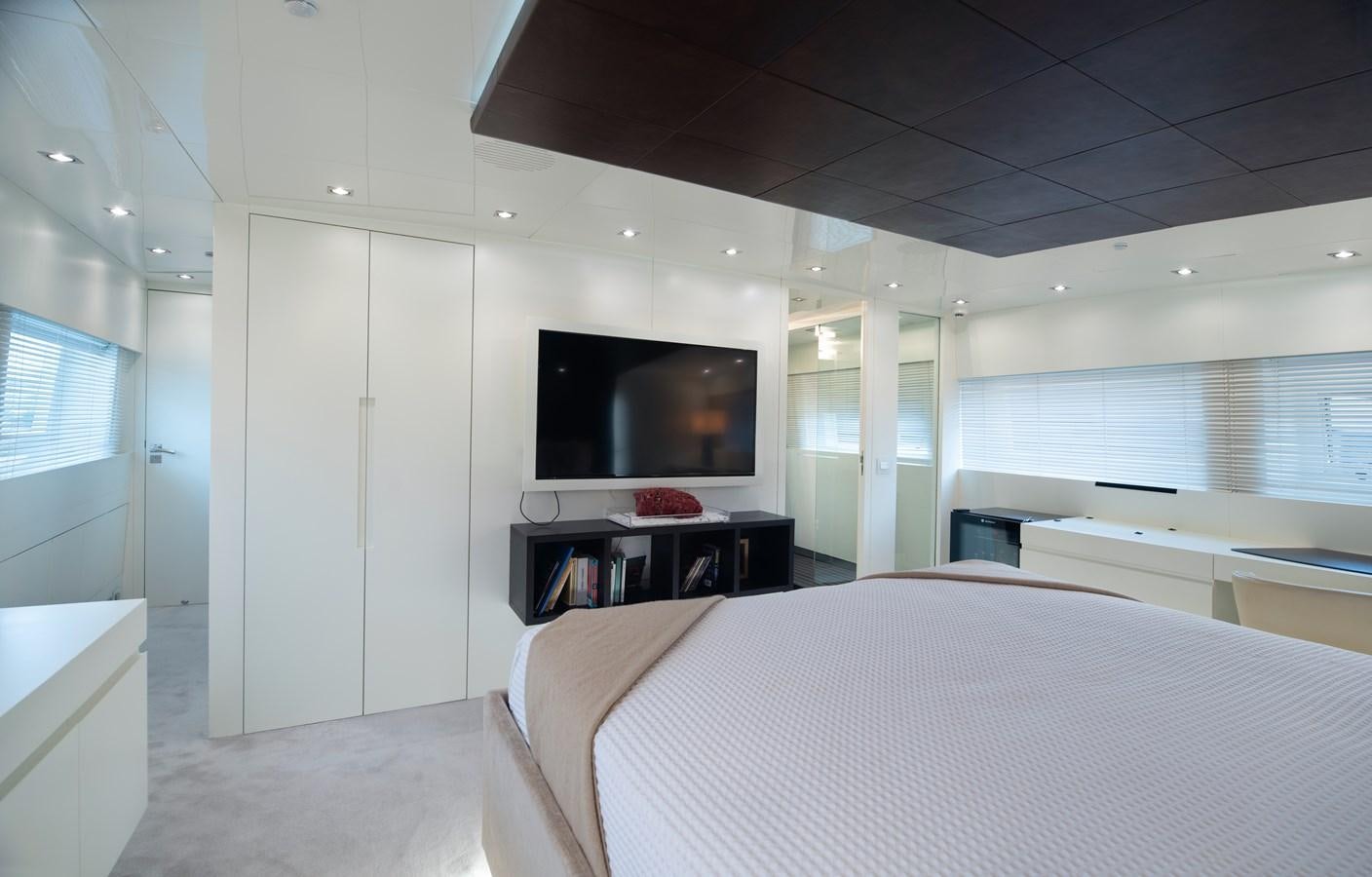 a room with a bed and a tv on the wall aboard XANAX Yacht for Sale