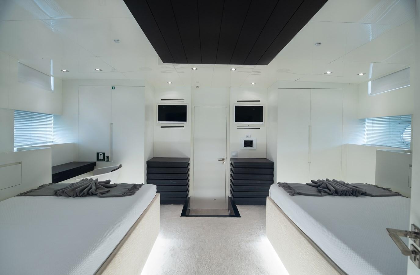 a room with a bed and a television aboard XANAX Yacht for Sale