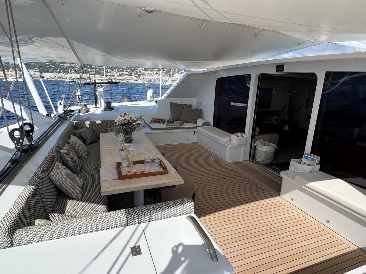 a boat with a table and chairs aboard MAGIC CAT Yacht for Sale