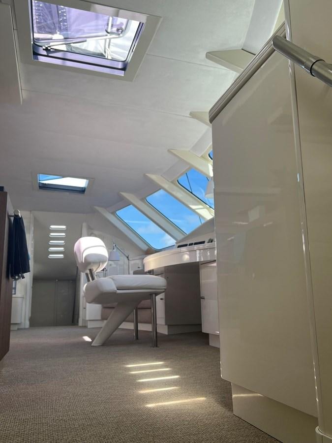 a room with a chair and a window aboard MAGIC CAT Yacht for Sale