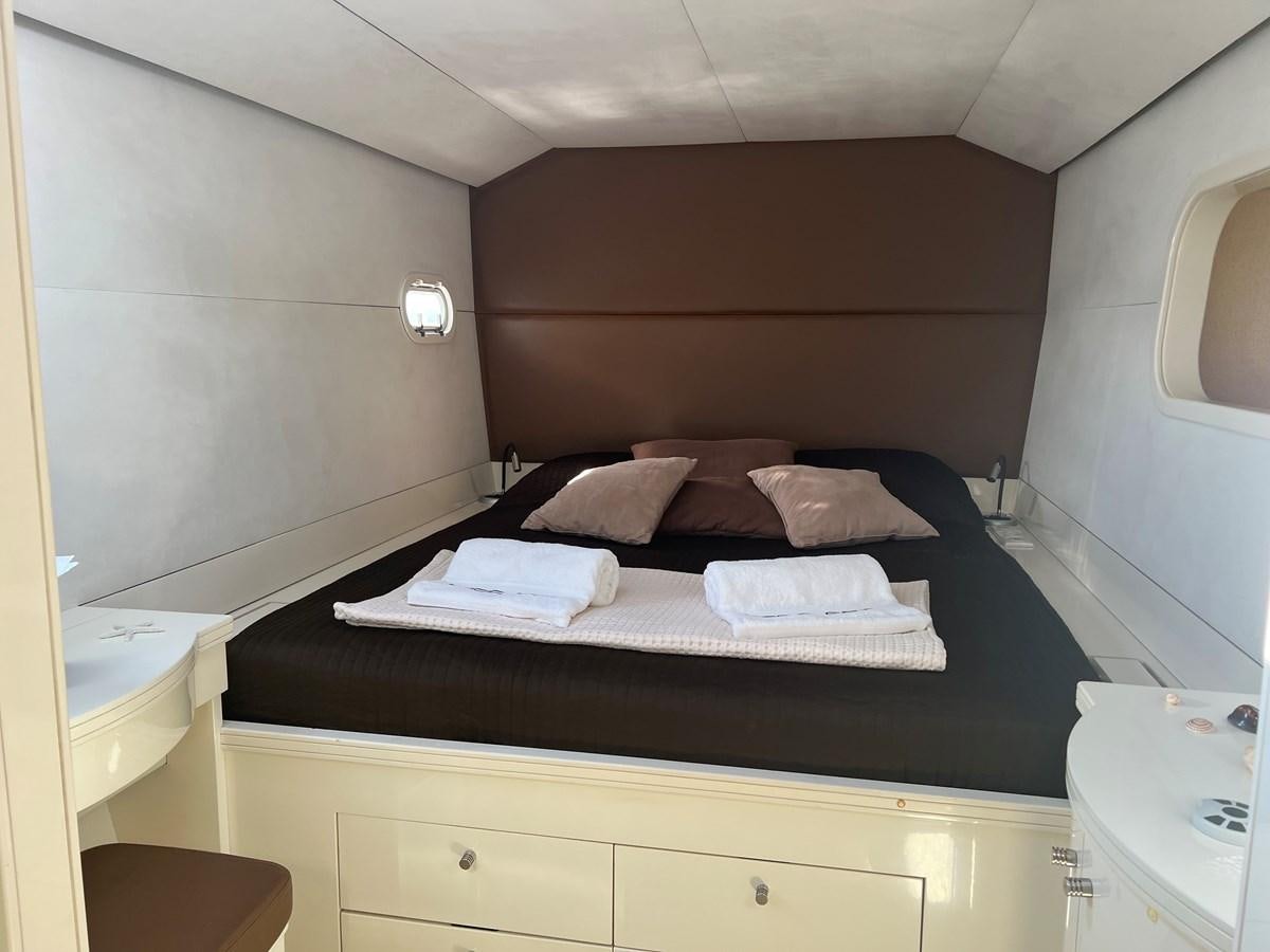 a bed with a black frame aboard MAGIC CAT Yacht for Sale