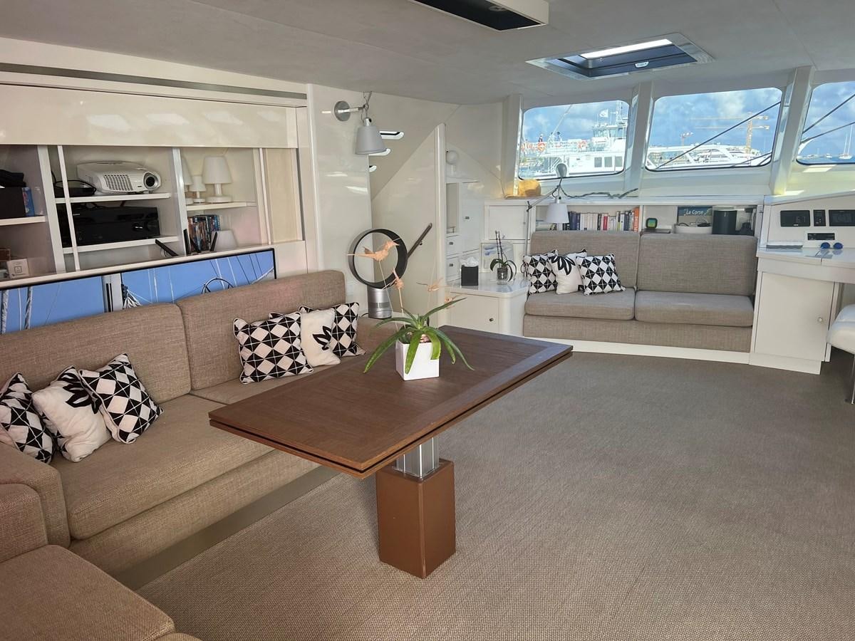 a living room with a couch and coffee table aboard MAGIC CAT Yacht for Sale