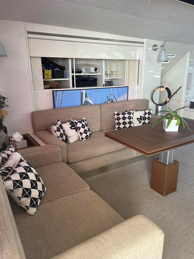 a living room with a brown couch aboard MAGIC CAT Yacht for Sale