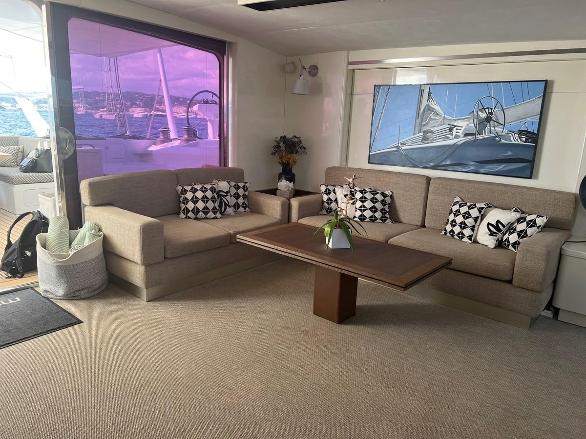 a living room with a couch and a coffee table aboard MAGIC CAT Yacht for Sale