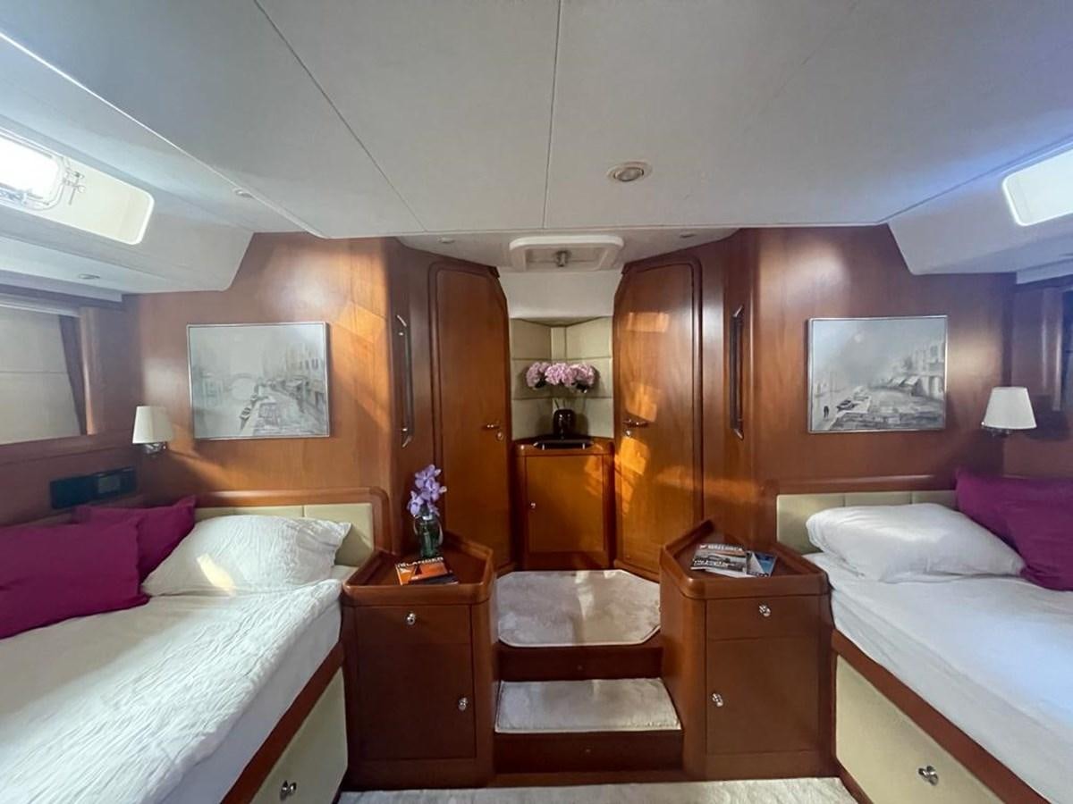 a room with a bed and a dresser aboard DUNJA Yacht for Sale