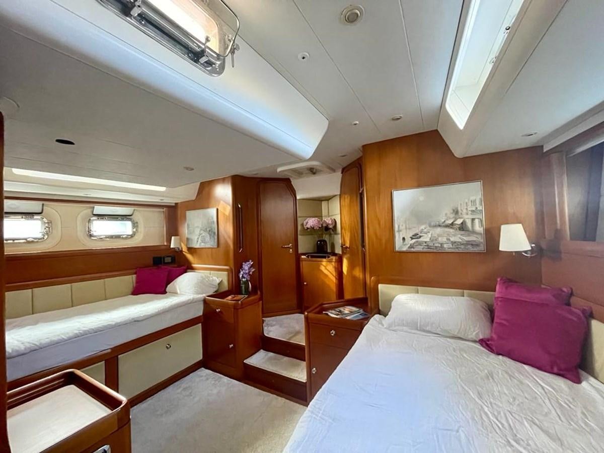 a room with a bed and a desk aboard DUNJA Yacht for Sale