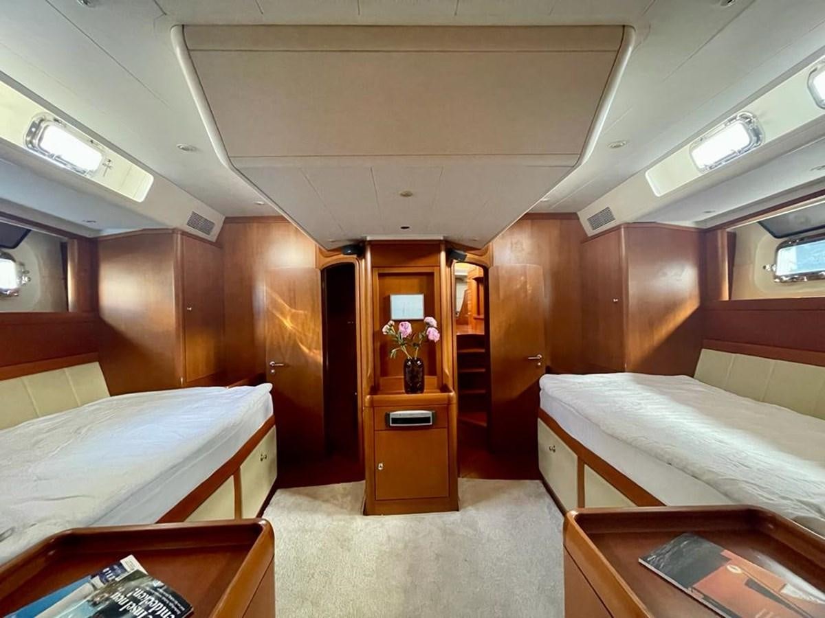 a room with a bed and a desk aboard DUNJA Yacht for Sale