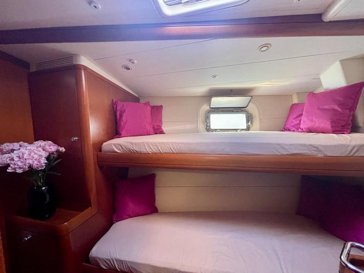 a bed with pink pillows aboard DUNJA Yacht for Sale