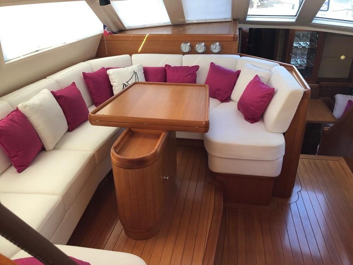 a couch with pink pillows aboard DUNJA Yacht for Sale