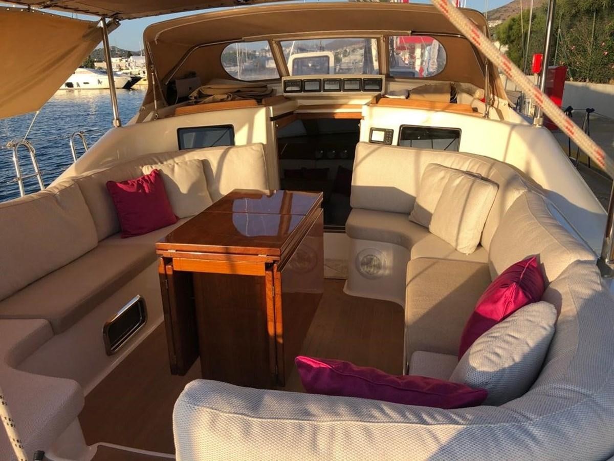 a boat with pillows and a table aboard DUNJA Yacht for Sale