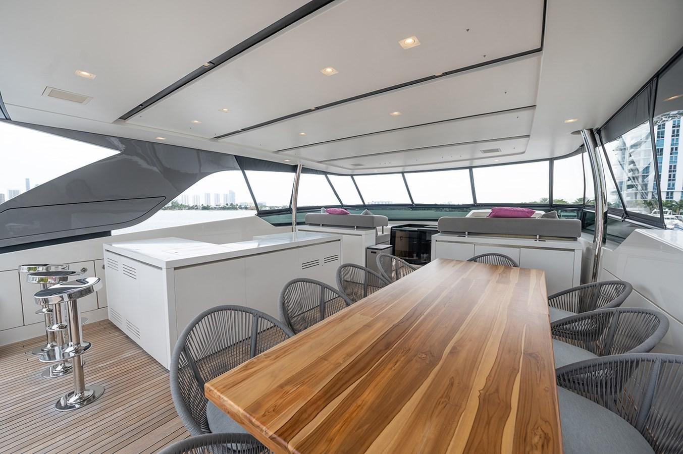 a large room with a table and chairs aboard RYEN Yacht for Sale
