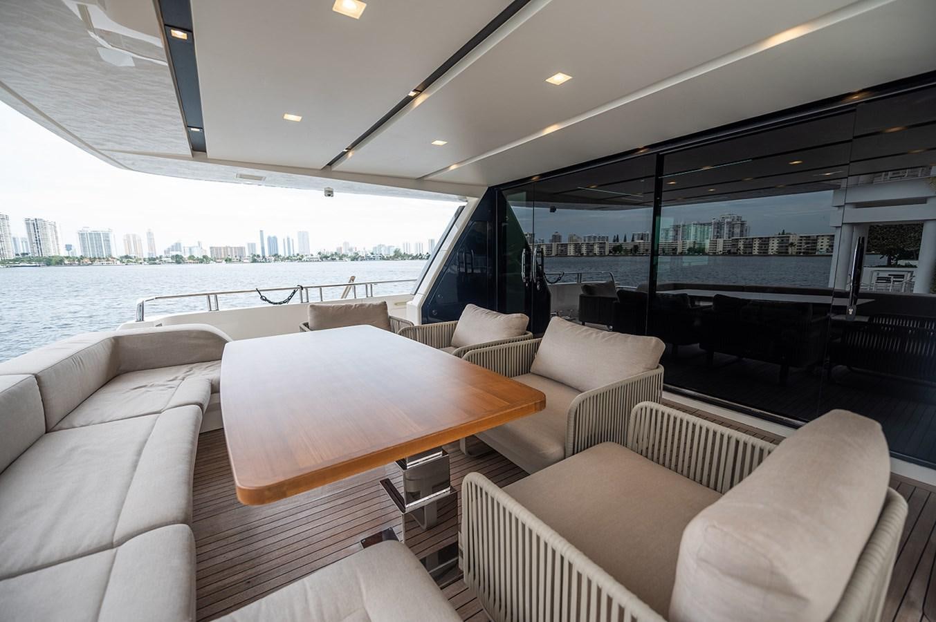 a room with couches and a table and a large body of water aboard RYEN Yacht for Sale