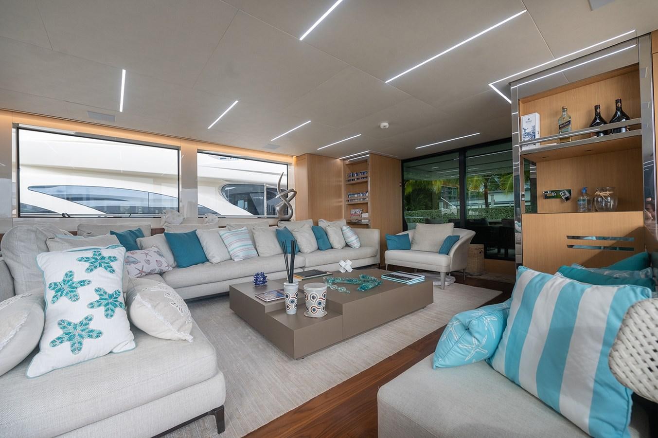 a living room with couches and a coffee table aboard RYEN Yacht for Sale