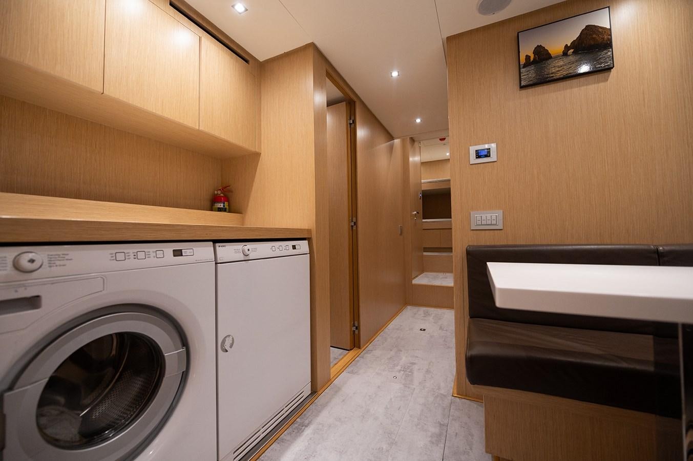 a laundry room with washer and dryer aboard RYEN Yacht for Sale