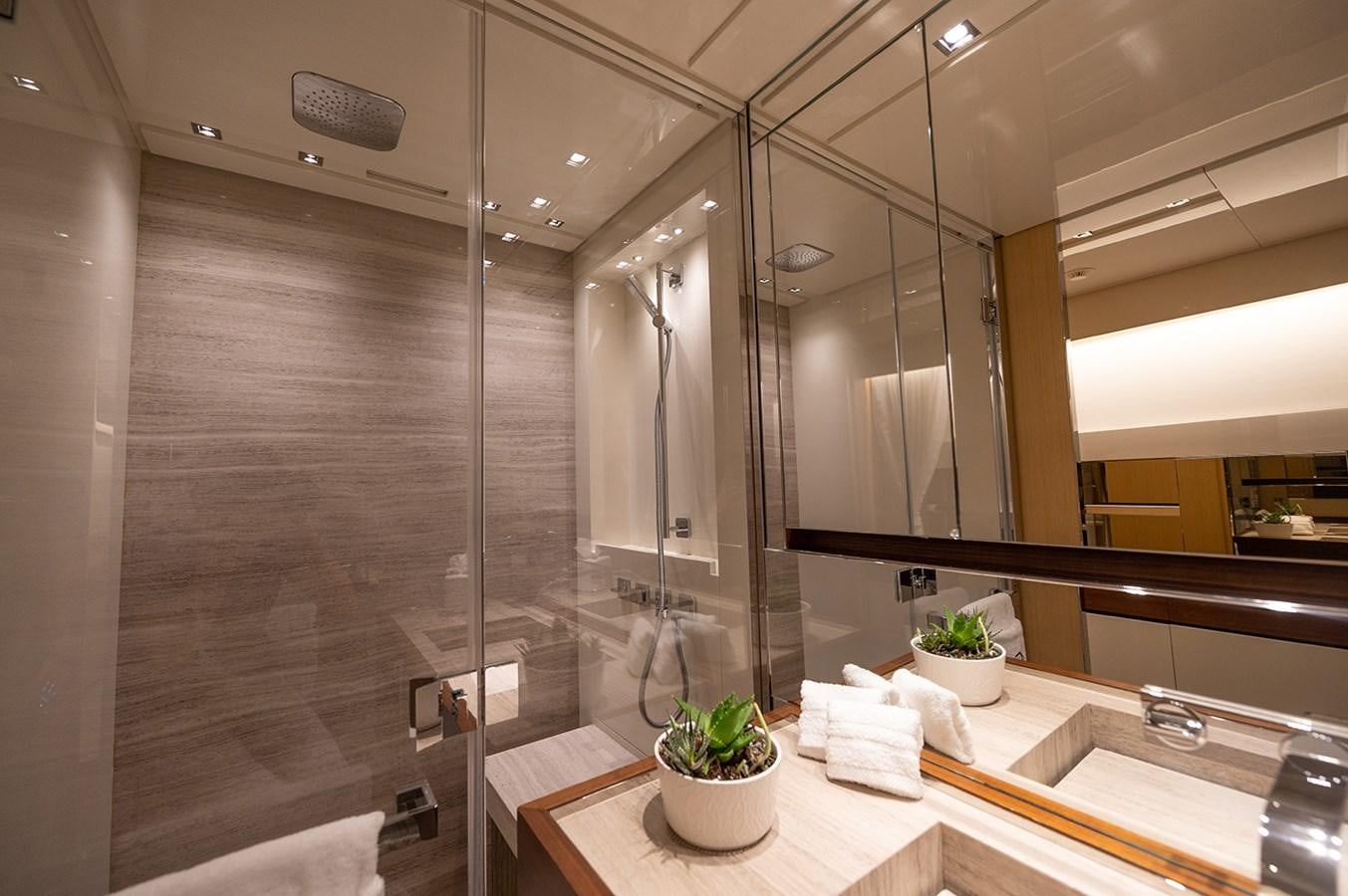 a bathroom with a glass wall aboard RYEN Yacht for Sale