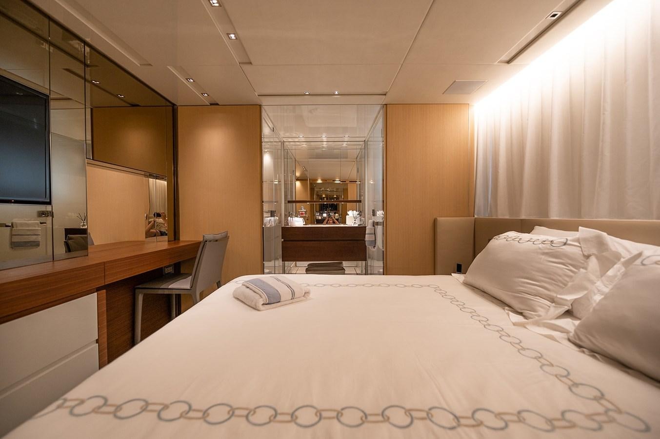 a hotel room with a bed and desk aboard RYEN Yacht for Sale