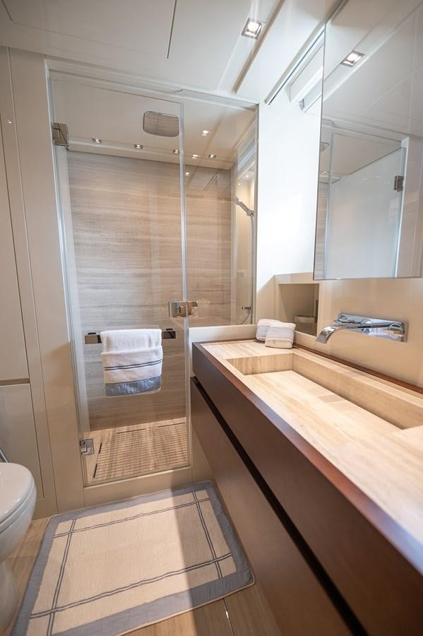 a bathroom with a glass shower aboard RYEN Yacht for Sale