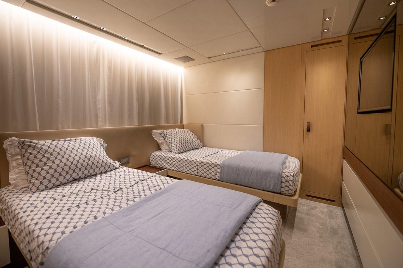 a room with beds and a door aboard RYEN Yacht for Sale