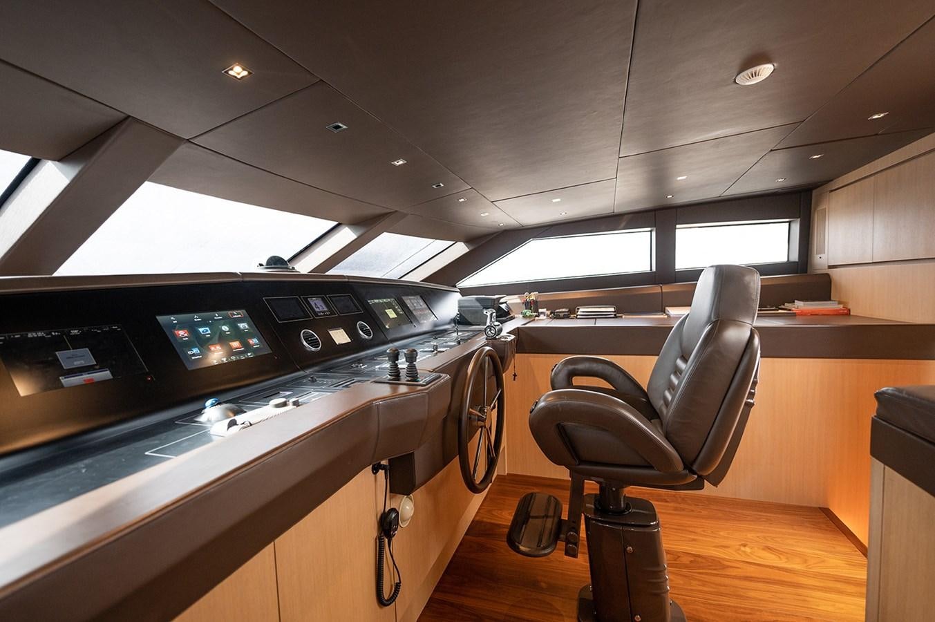 a room with a desk and chairs aboard RYEN Yacht for Sale