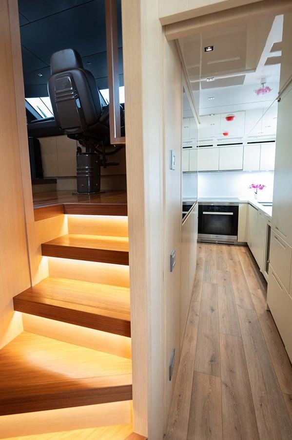 a hallway with a black stove and a white wall aboard RYEN Yacht for Sale