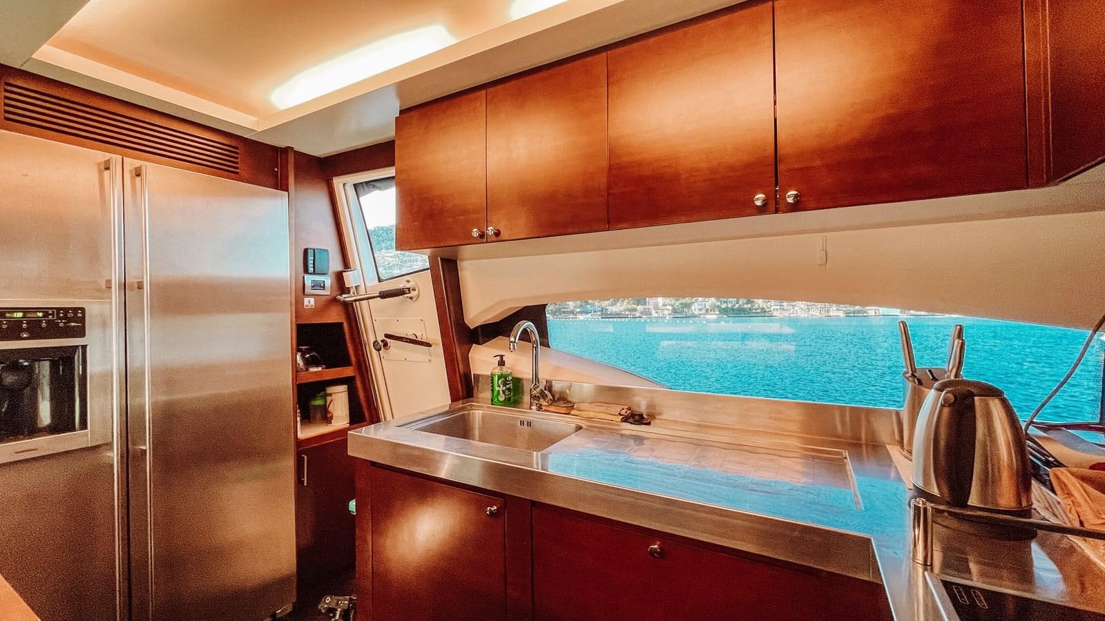 a kitchen with a large stainless steel refrigerator aboard AZIMUT 88 Yacht for Sale