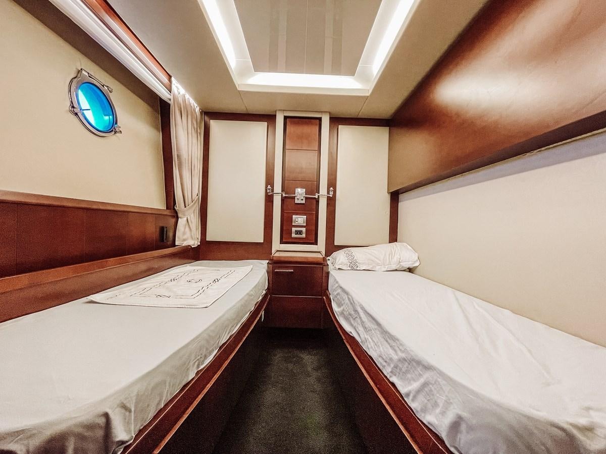 a room with beds and a window aboard AZIMUT 88 Yacht for Sale