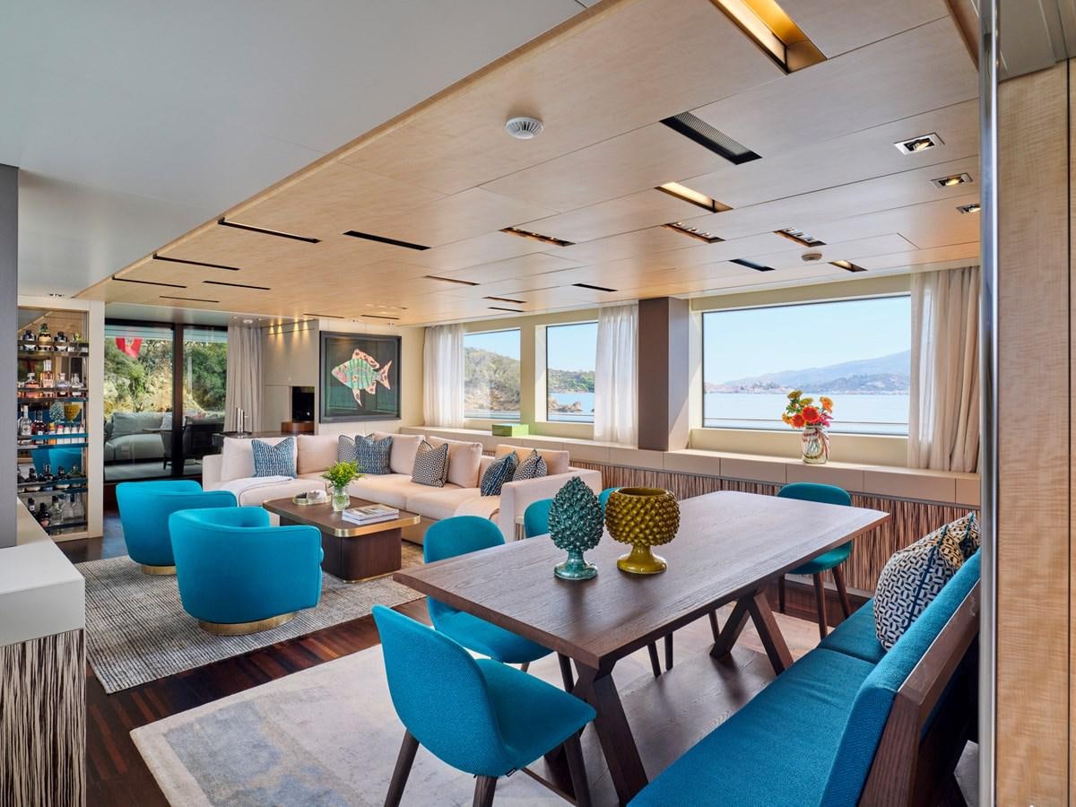 a living room with a table and chairs aboard RARE DIAMOND Yacht for Sale