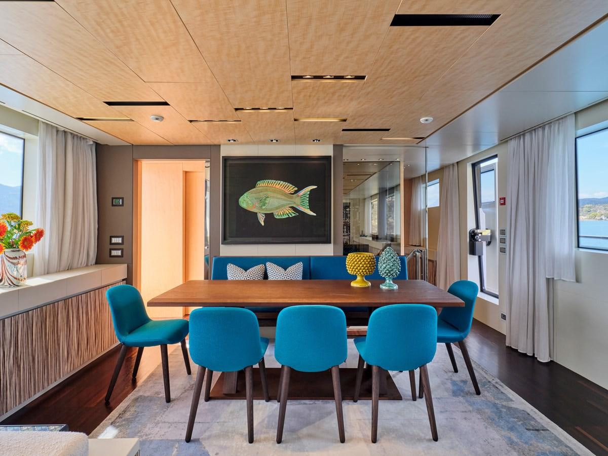a room with a table and chairs aboard RARE DIAMOND Yacht for Sale