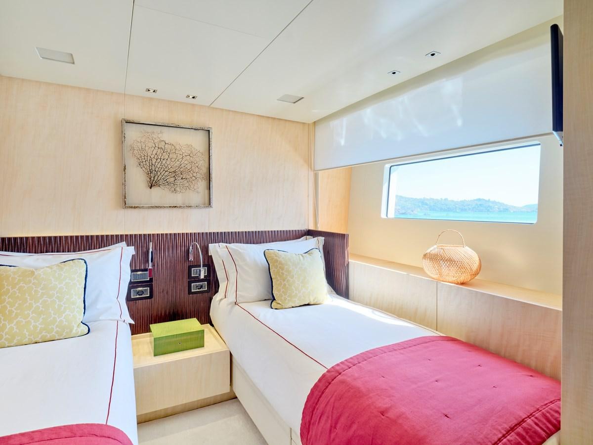a room with a bed and a window aboard RARE DIAMOND Yacht for Sale