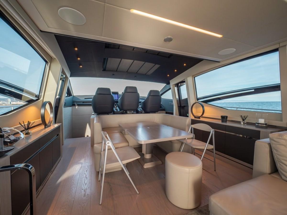 inside of a vehicle with tables and chairs and a large window aboard SURVIVOR Yacht for Sale