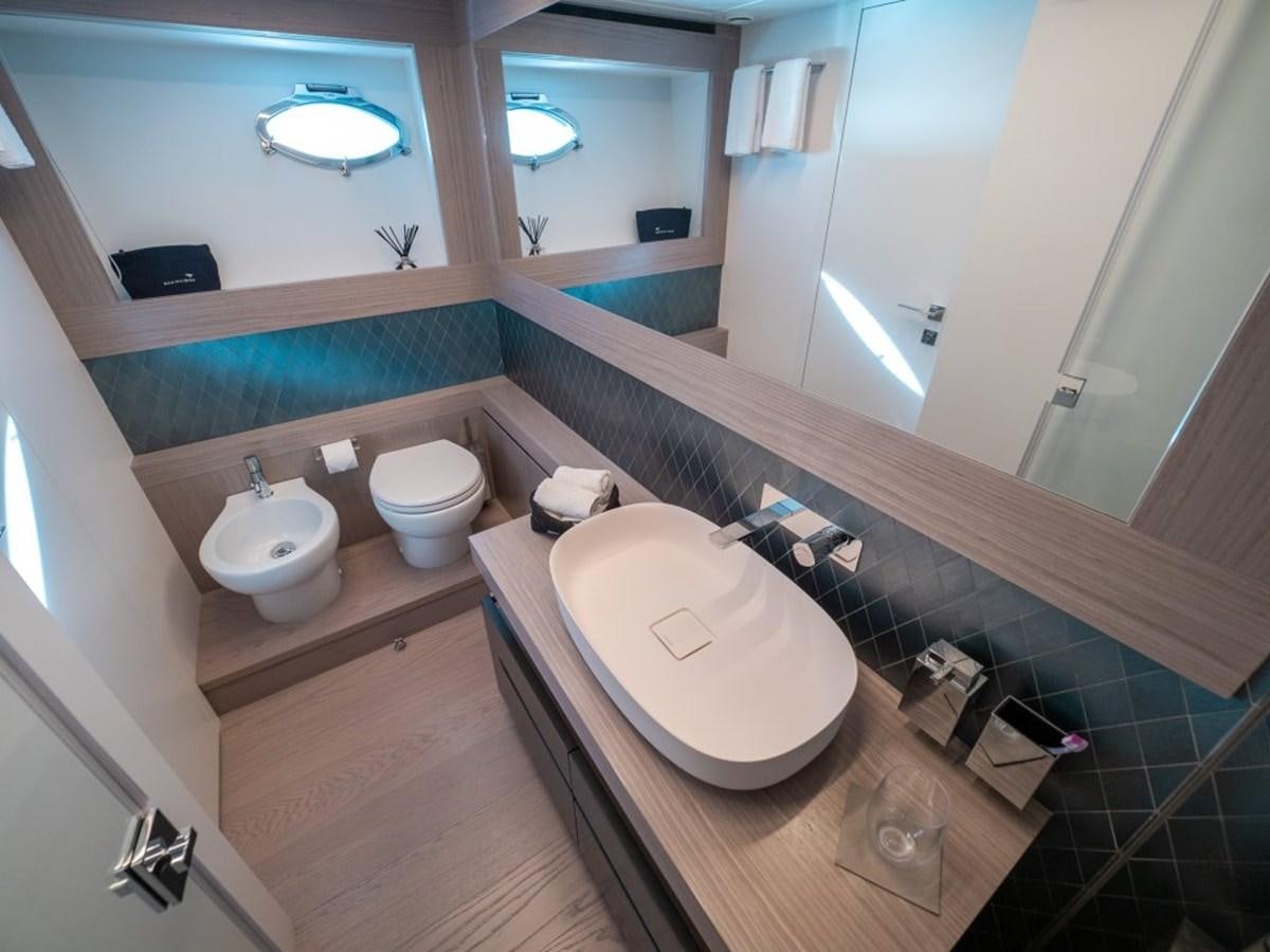 a bathroom with a sink and a mirror aboard SURVIVOR Yacht for Sale