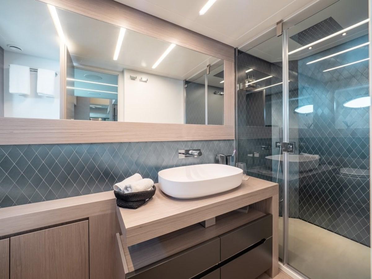 a bathroom with a glass shower aboard SURVIVOR Yacht for Sale