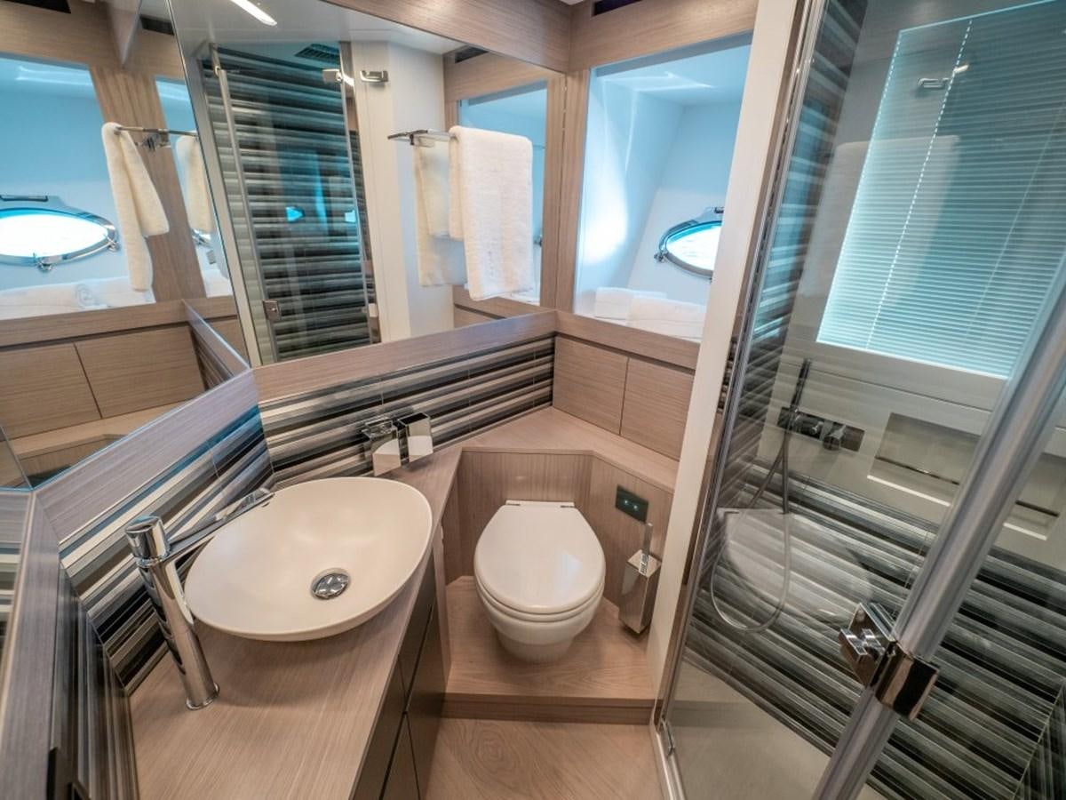 a bathroom with a glass shower aboard SURVIVOR Yacht for Sale