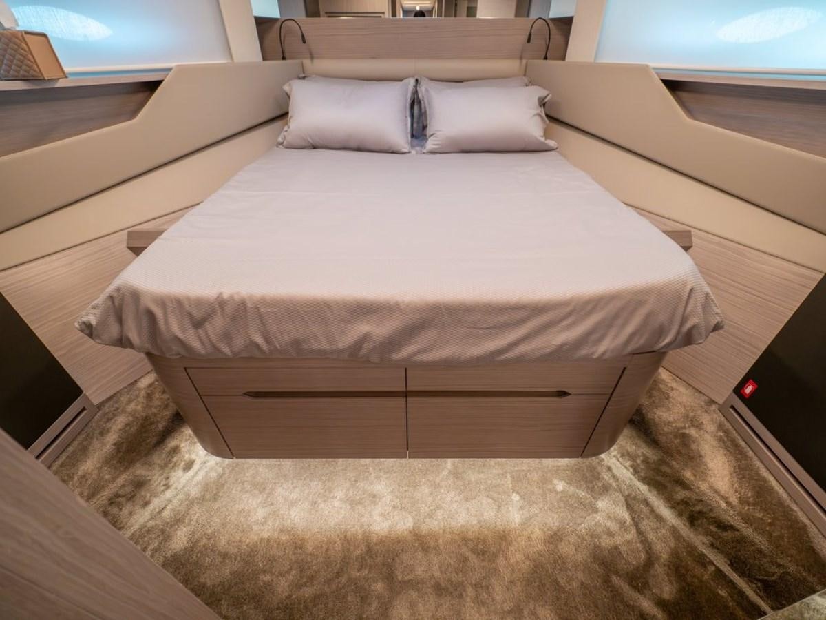 a bed with white sheets aboard SURVIVOR Yacht for Sale